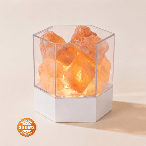Modern Himalayan salt lamp glowing warm amber, rough salt chunks in a clear hexagonal case, with a 30-day money-back guarantee badge