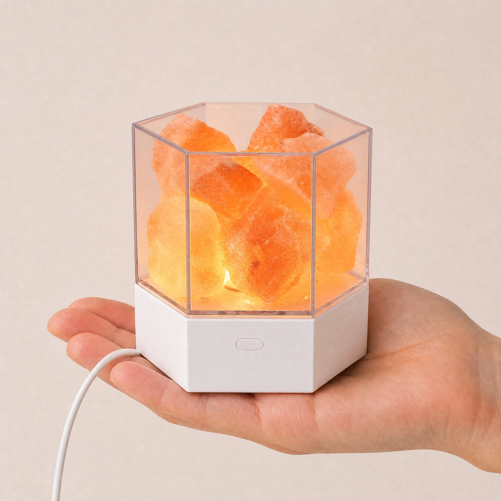 Modern Himalayan salt lamp size shown on a desk with its USB cord visible