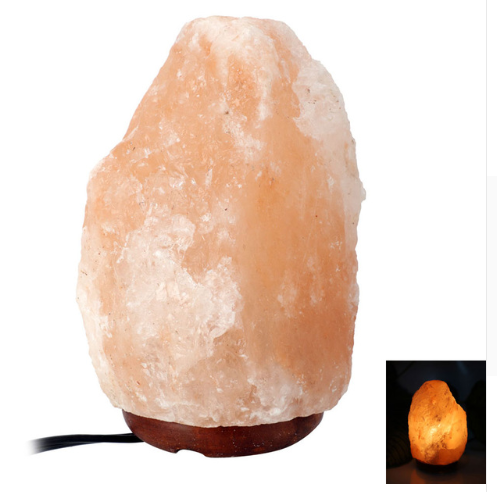Natural Himalayan pink salt lamp with a hand-carved crystal glowing warm amber