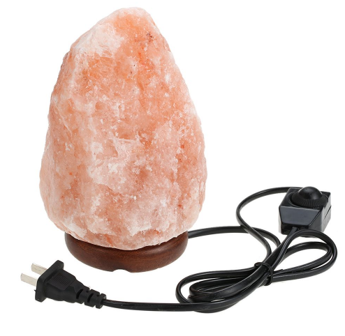 Natural Himalayan pink salt lamp with a hand-carved crystal glowing warm amber