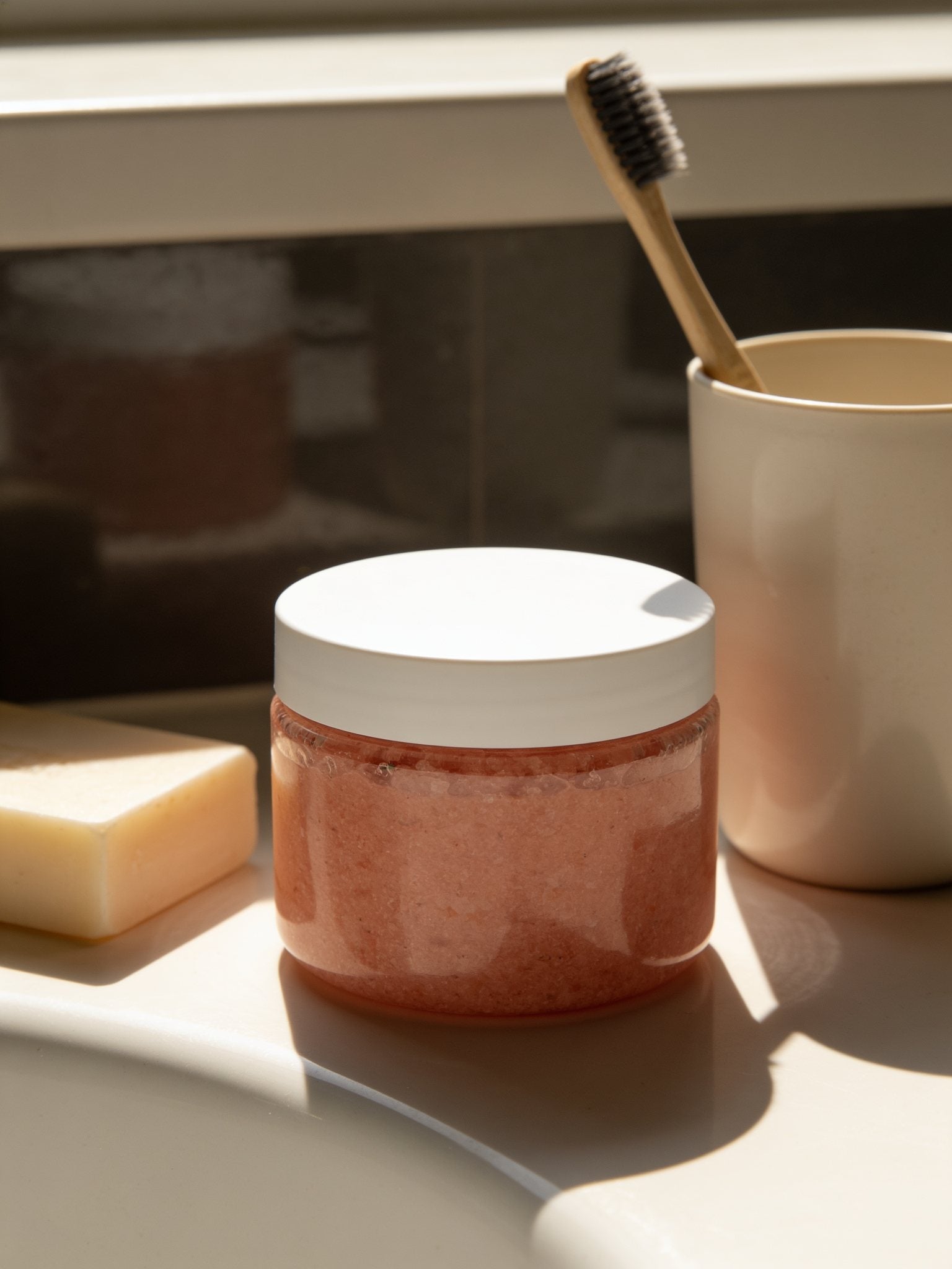 Himalayan salt body scrub jar size shown next to a soap bar and toothbrush