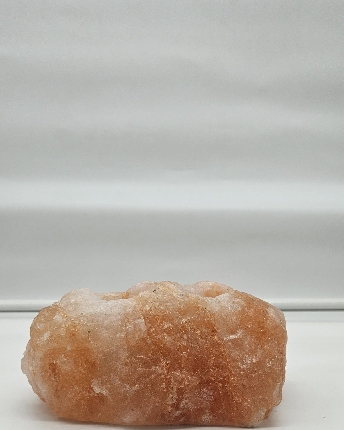 Two well salt candle holder in daylight from the side
