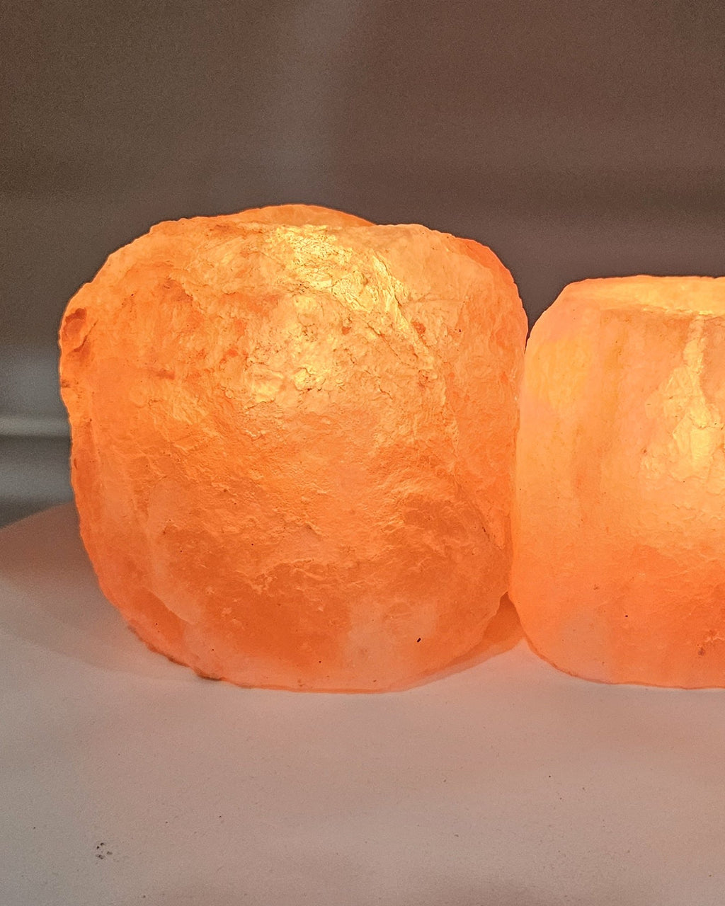 Natural salt candle holders in daylight, showing the rough outer surface