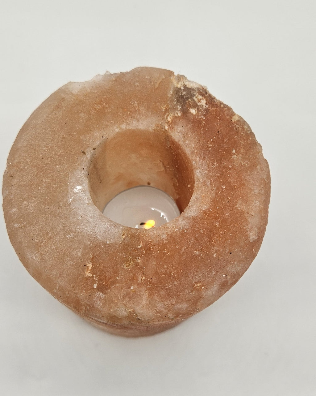 Cylinder salt candle holder lit from above
