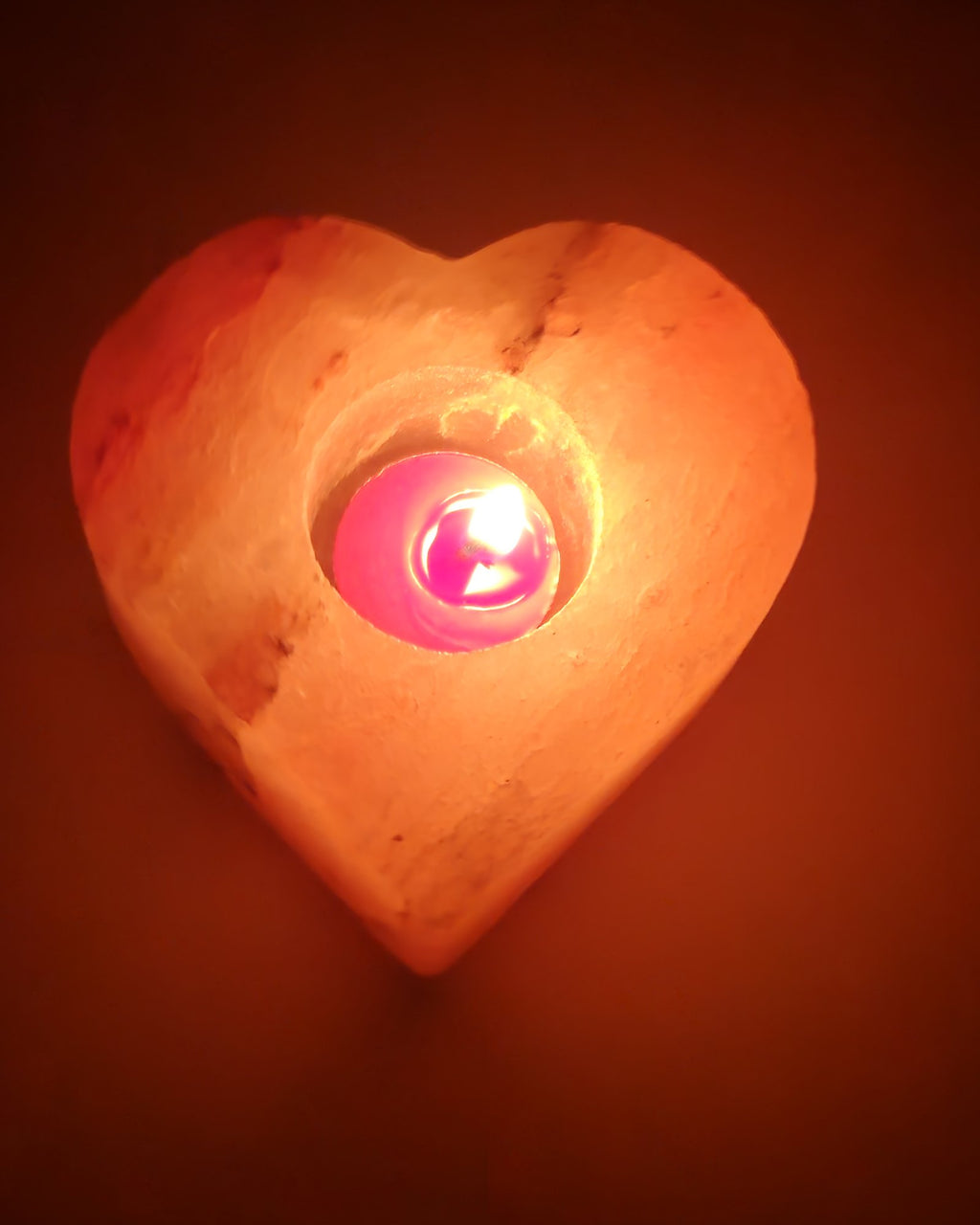 Heart shaped salt candle holder with a lit tea light