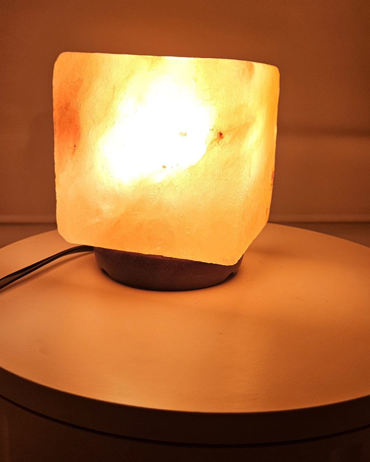Himalayan salt cube lamp lit, showing the veining in the block