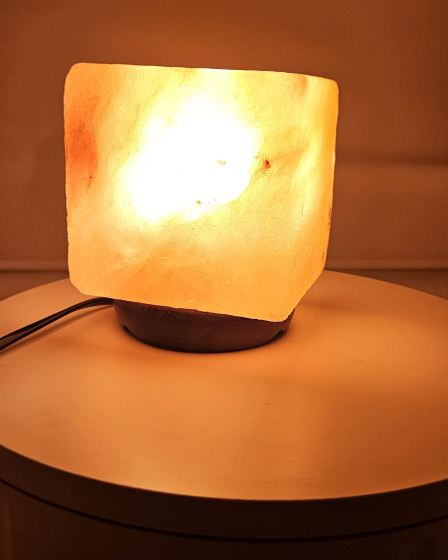 Himalayan salt cube lamp lit, showing the veining in the block
