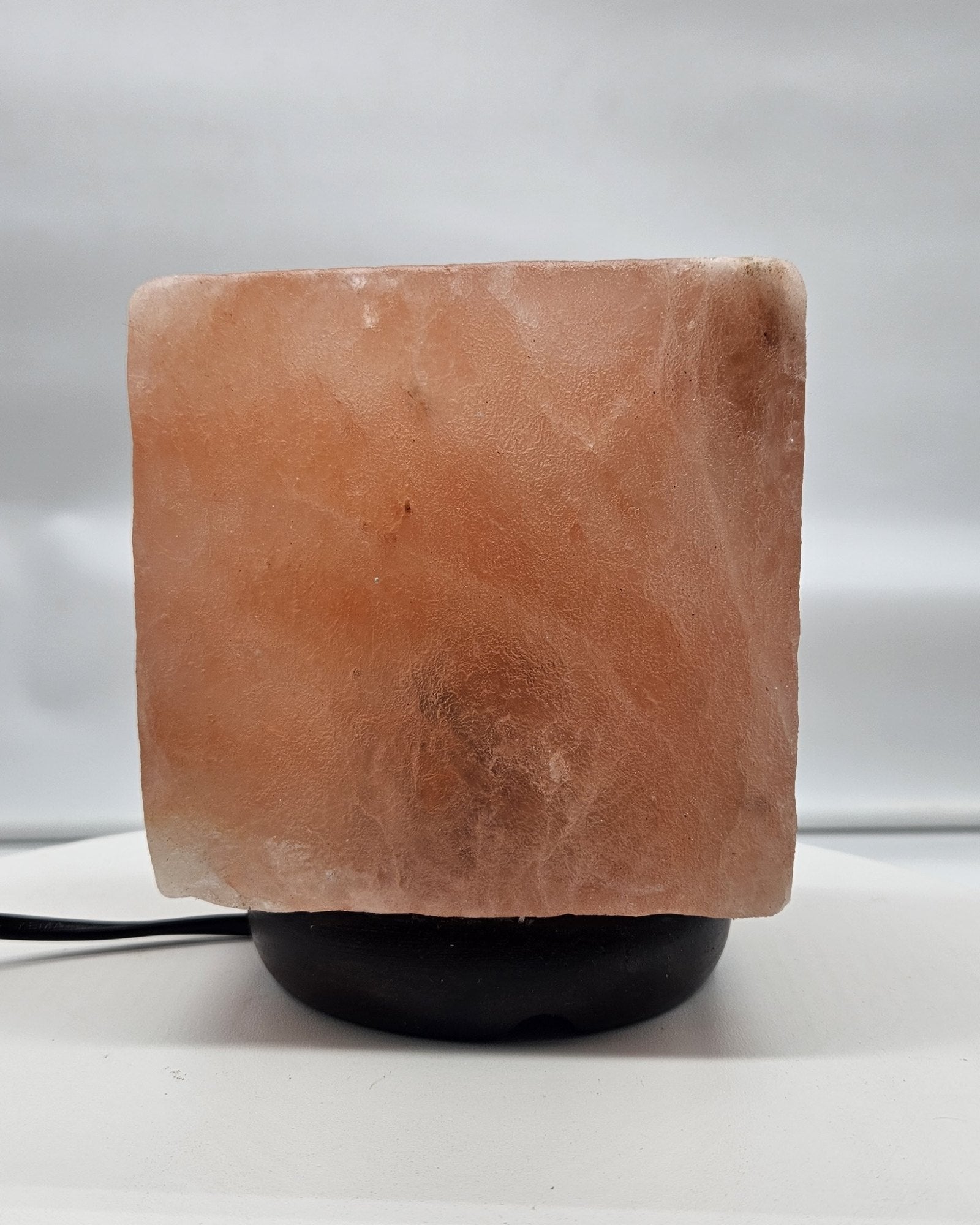 Himalayan salt cube lamp unlit in daylight, showing the natural colour of the salt