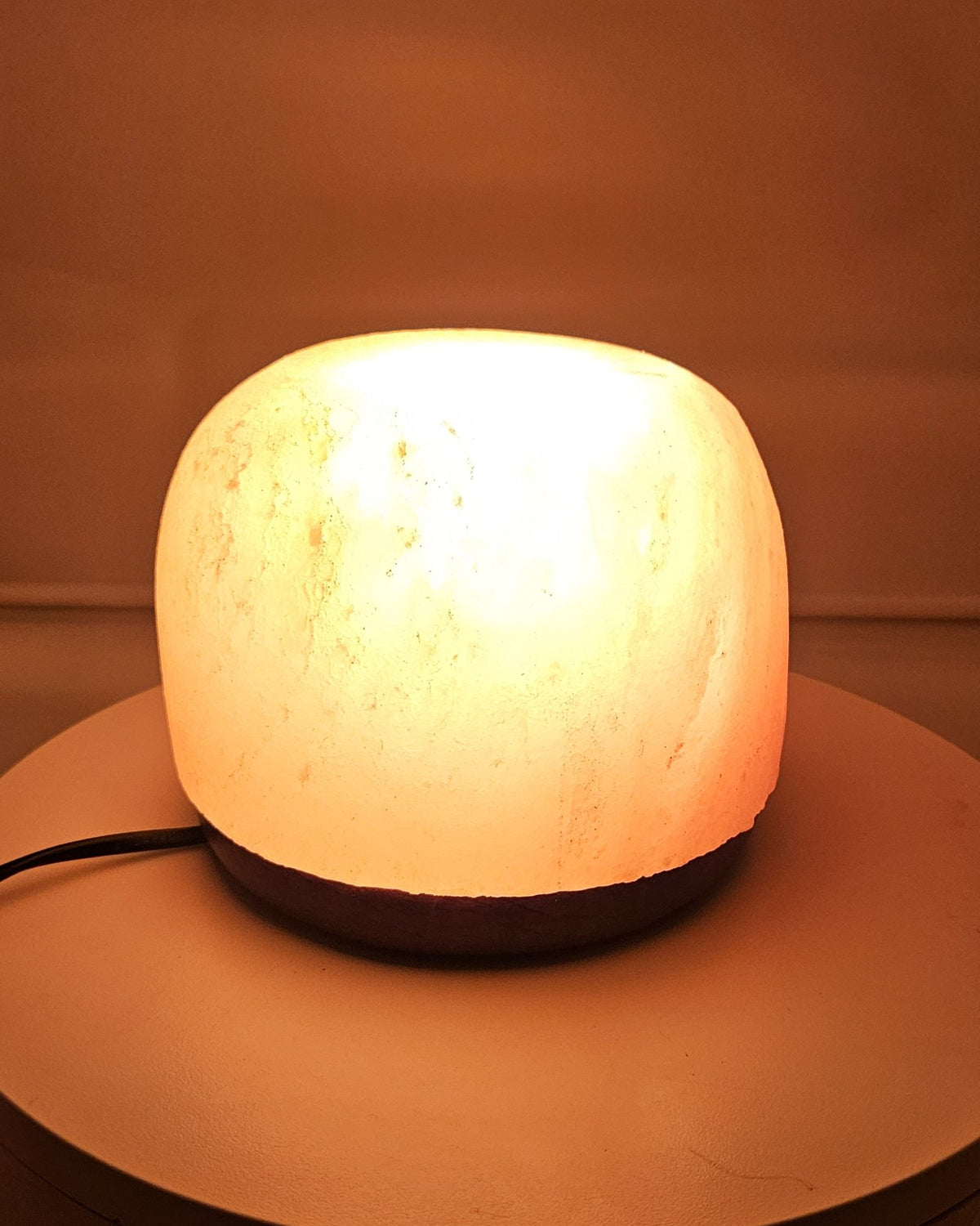 Himalayan salt dome lamp lit, showing the rounded shape