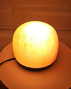 Himalayan salt dome lamp lit, warm glow through the salt
