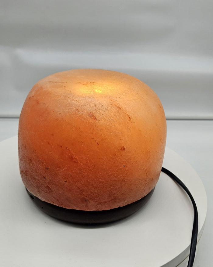Himalayan salt dome lamp in daylight, showing the surface texture