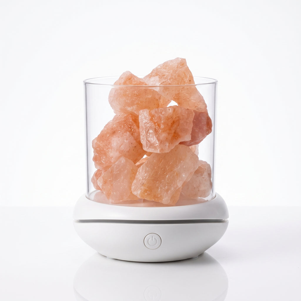 Himalayan salt glow lamp switched off, pink salt chunks in a clear cup on a white base