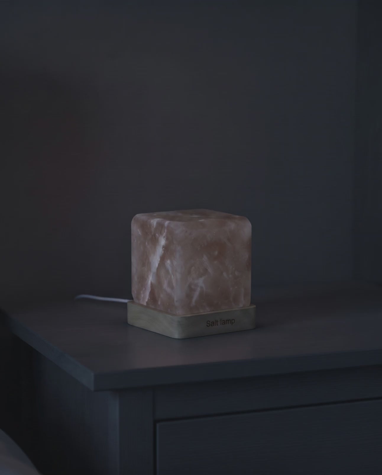 Himalayan salt night lamp blooming from dark to a warm amber glow