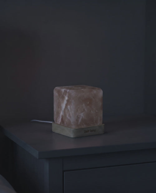Himalayan salt night lamp blooming from dark to a warm amber glow