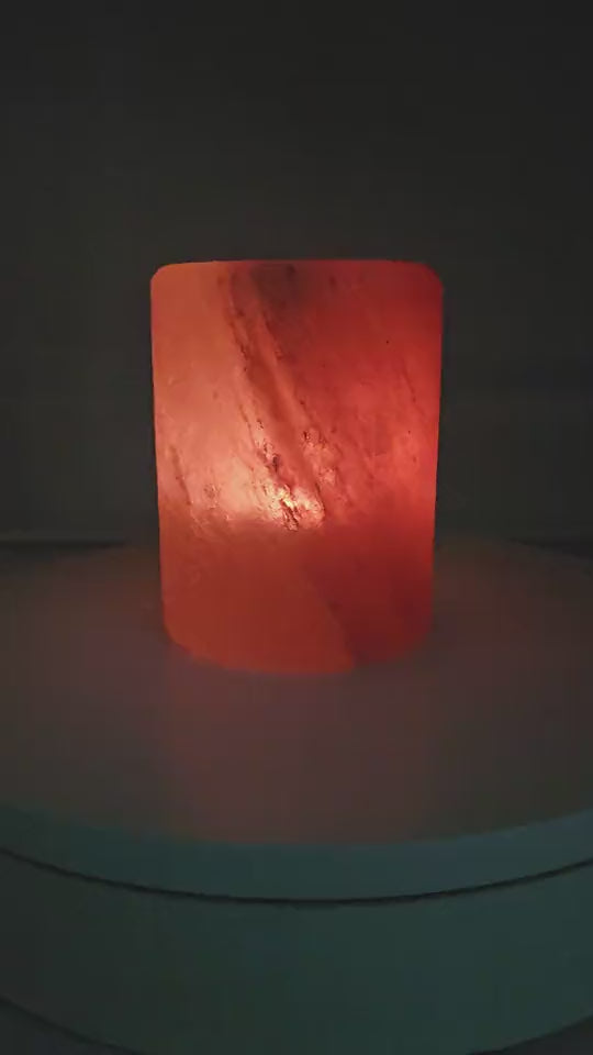 Cylinder salt candle holder with a lit tea light