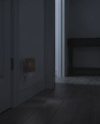 Himalayan salt wall lamp glowing warm in a hallway at night