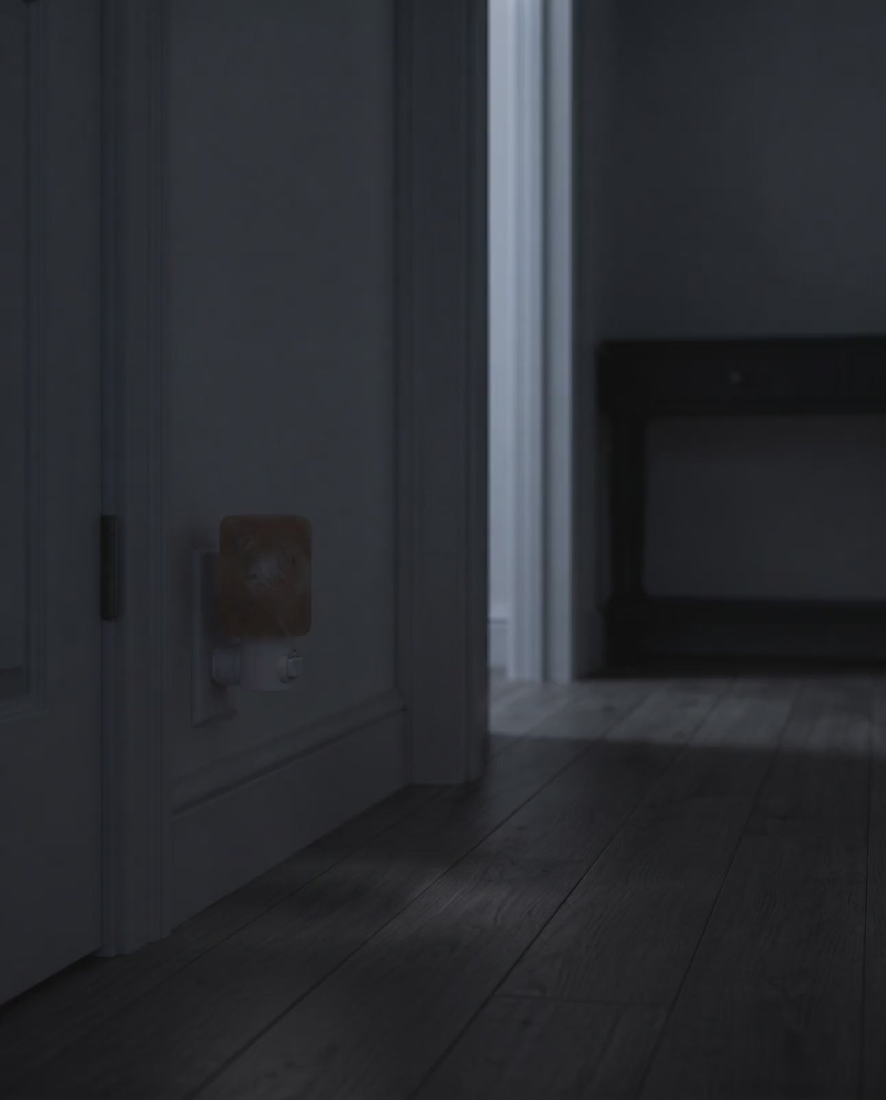 Himalayan salt wall lamp blooming from dark to a warm glow in a hallway