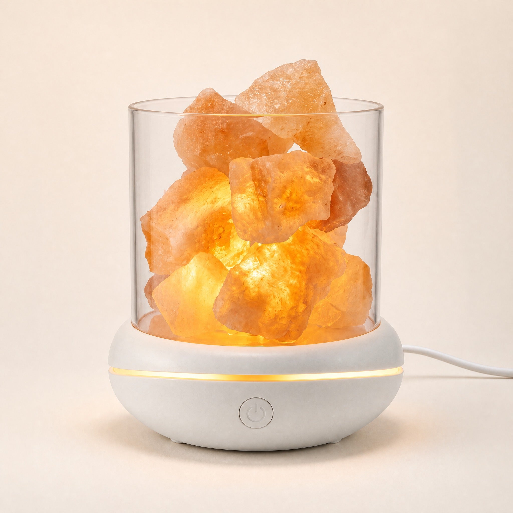 Himalayan pink salt glow lamp and essential oil diffuser glowing warm, white USB cable attached