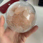 The mini salt lamp held in one hand, showing it is small enough to sit in a palm
