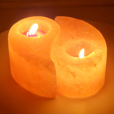 Ying yang Himalayan salt tea light holder, the two interlocking halves standing side by side, both lit