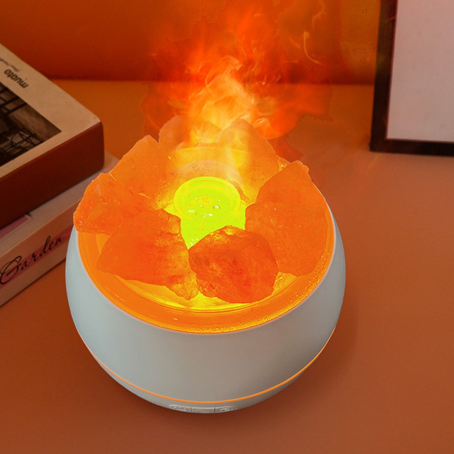 Overhead angle of the humidifier running, showing the central mist outlet lit green inside the ring of salt pieces