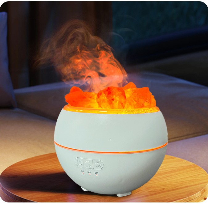 The humidifier lit and misting on a round wooden side table in a living room at night