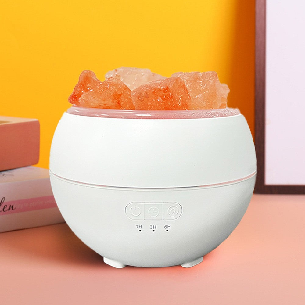 The humidifier switched off on a desk, showing the salt pieces on top and the three control buttons with 1H, 3H and 6H timer indicators