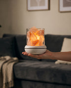 Hand holding the cordless salt glow lamp with no cord and a warm glow