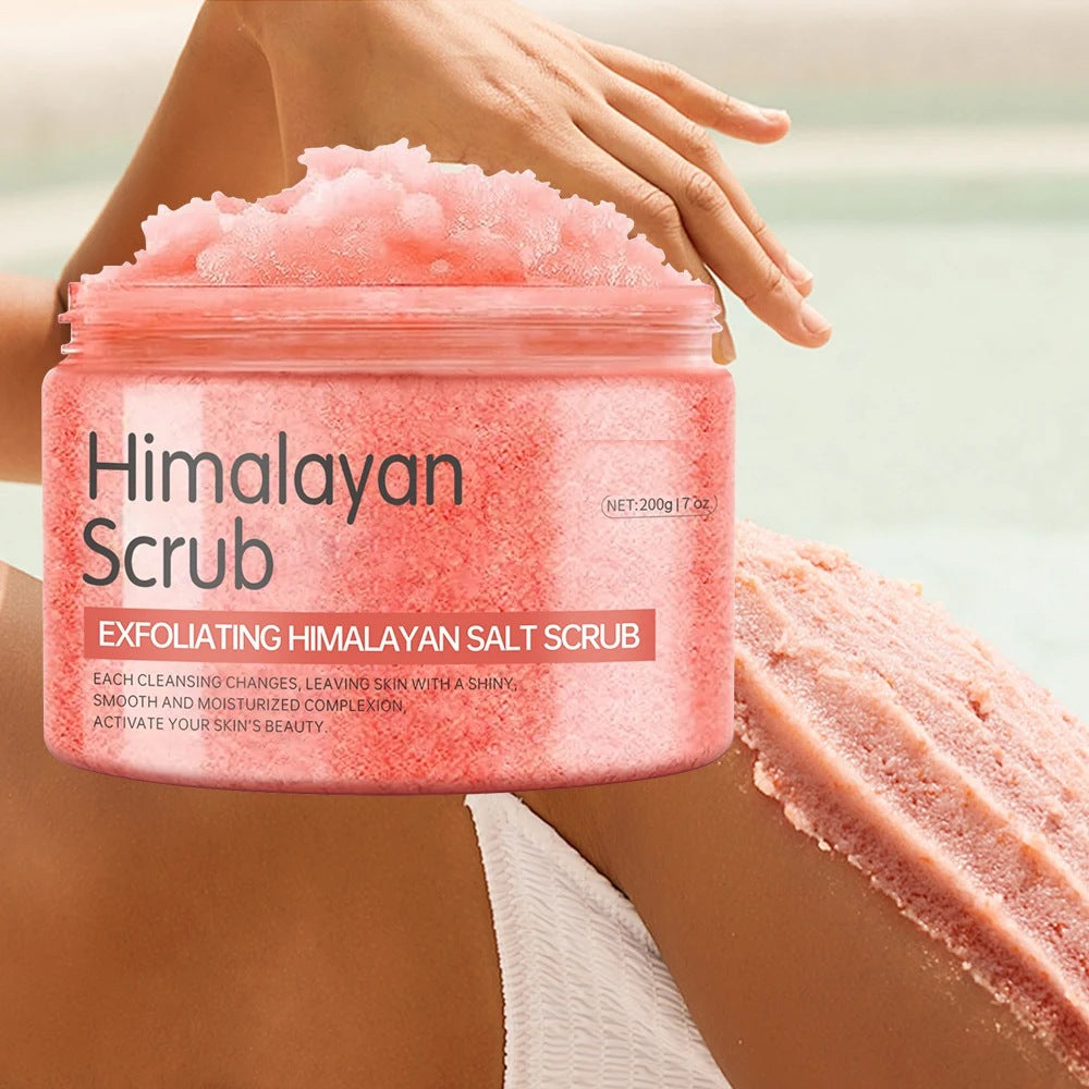 The real Himalayan salt body scrub jar held in a hand, piled with pink salt scrub, 200 g / 7 oz printed on the label
