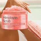 The real Himalayan salt body scrub jar held in a hand, piled with pink salt scrub, 200 g / 7 oz printed on the label