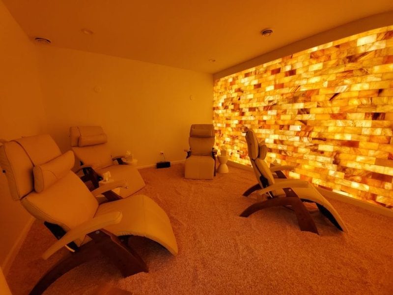 A warm glowing wall of stacked Himalayan salt bricks