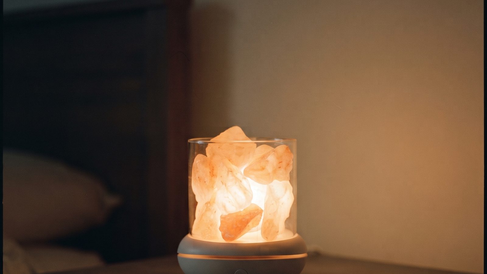 A Himalayan salt lamp glowing warmly in a dark, calm room