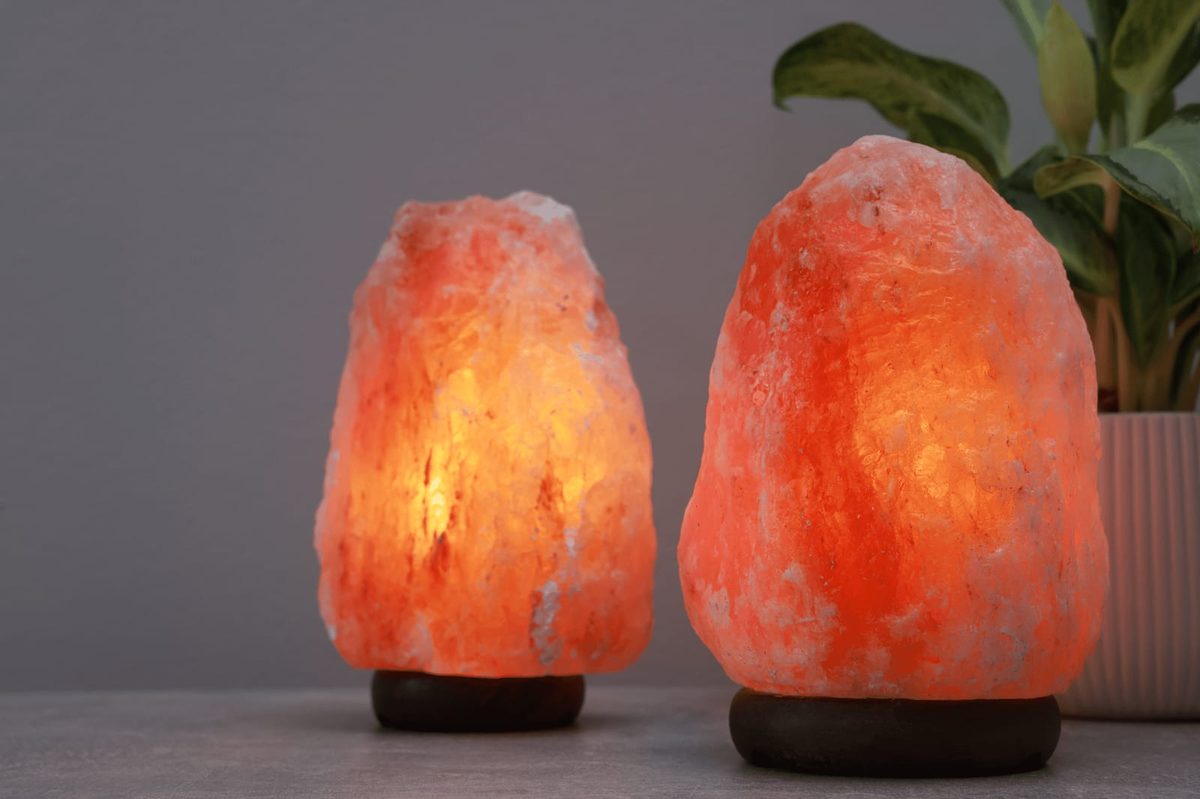 Two natural Himalayan salt lamps glowing warmly, showing natural colour and shape variation
