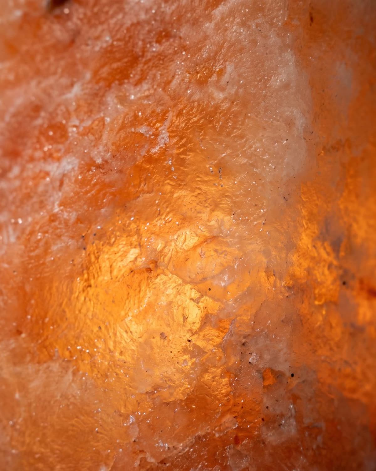 A single hand-carved Himalayan salt crystal glowing warm amber
